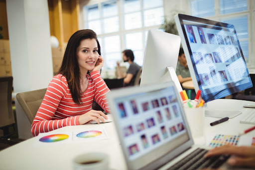 Portrait of graphic designer working at her desk in the office