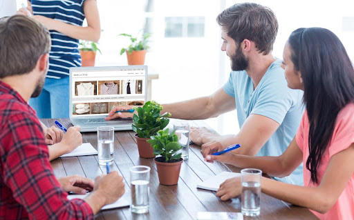 Business team using a laptop  against shop with style homepage