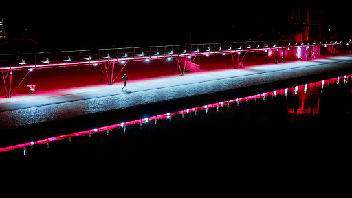 a runner, alone at the waterway's edge