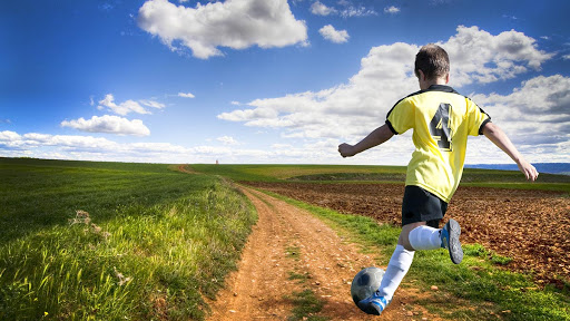 Freedom. Boy playing football