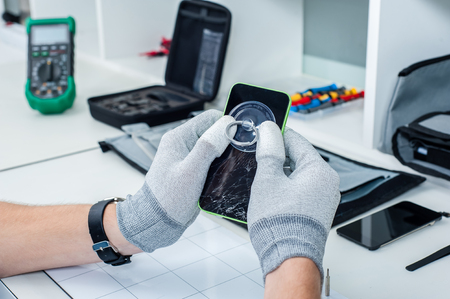 46987694 - close-up photos showing process of mobile phone repair